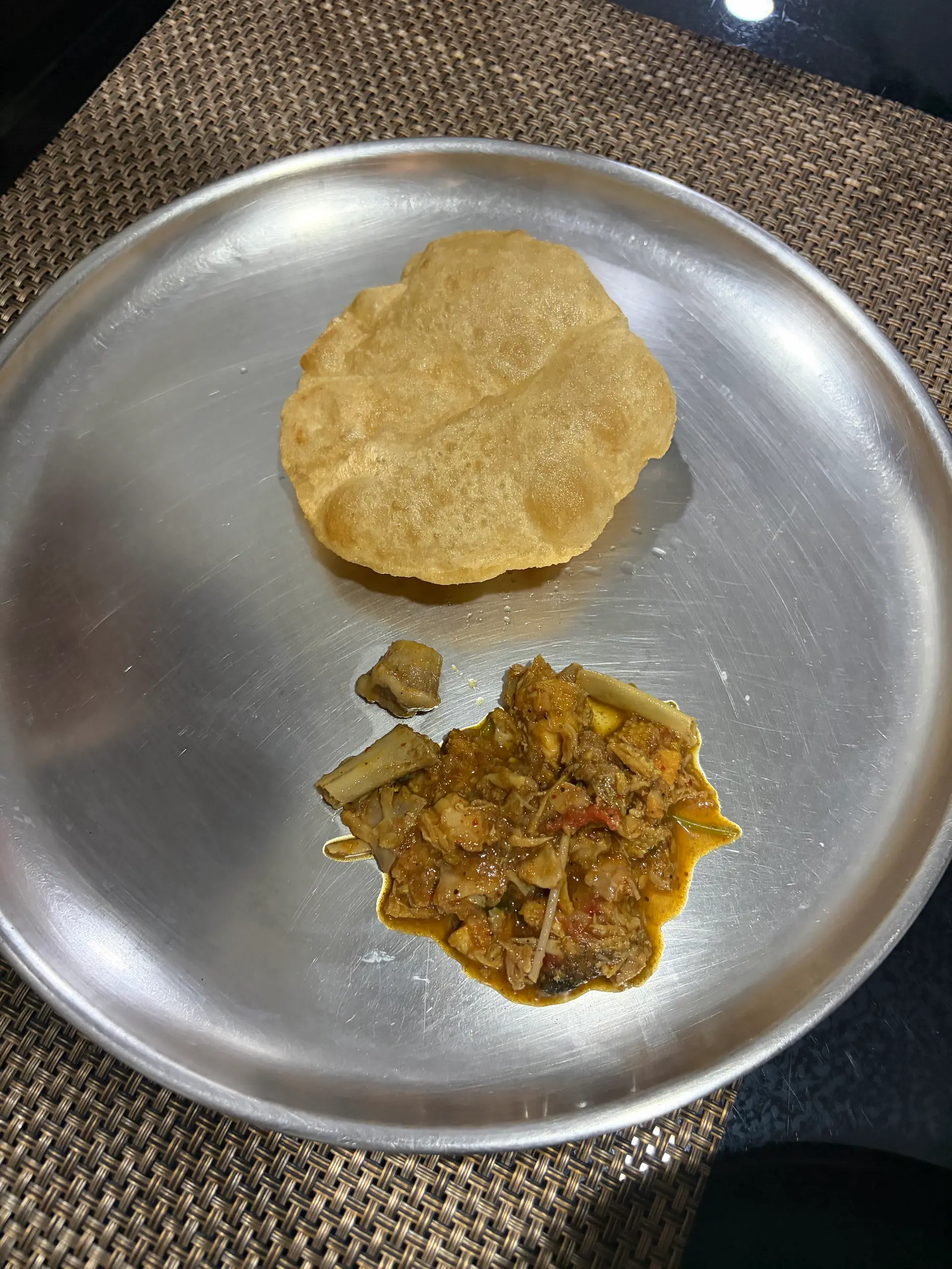 A cook's photo of Poori and Naatukodi Pulusu