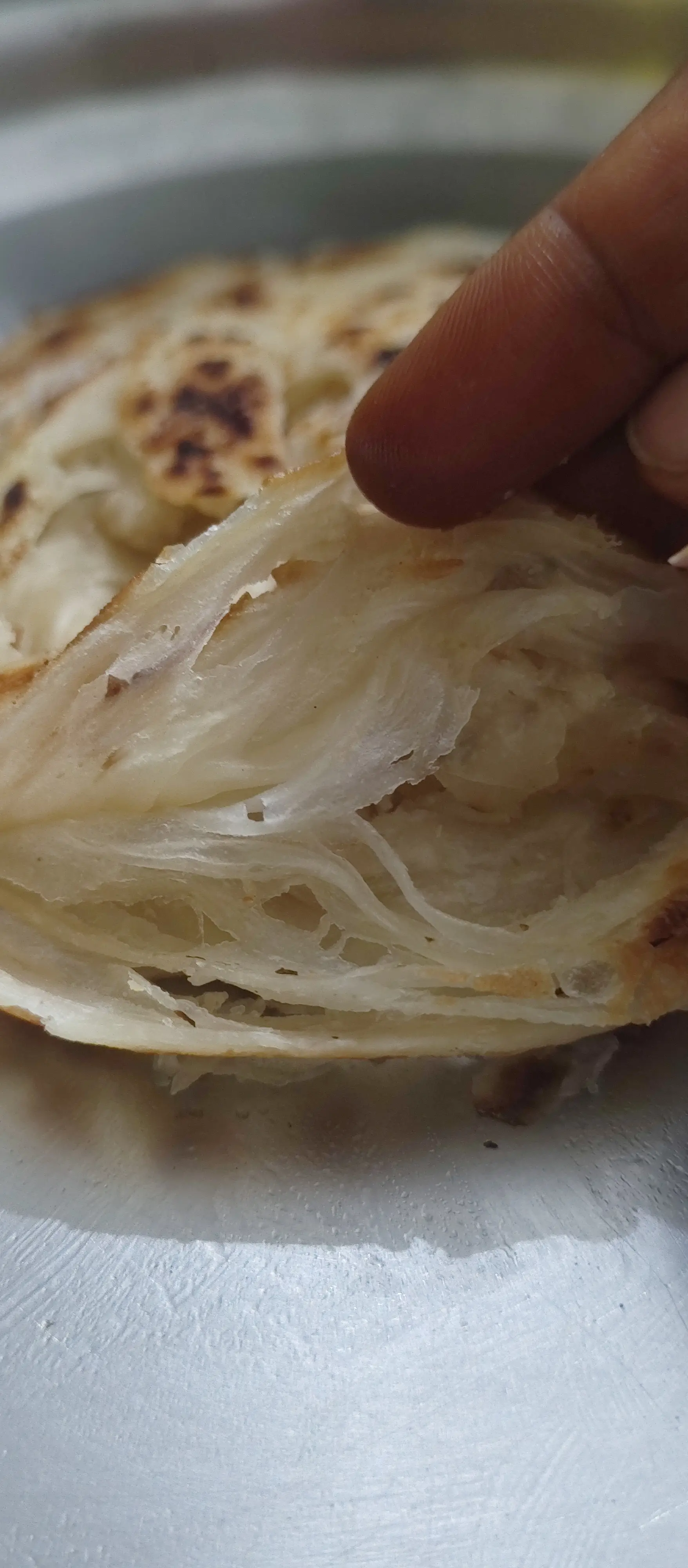 A cook's photo of Parotta