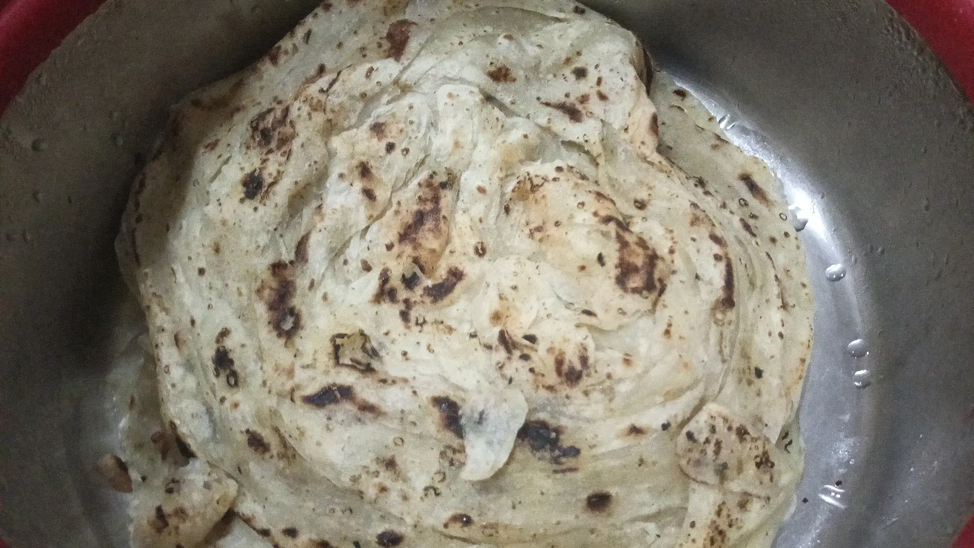 A cook's photo of Parotta