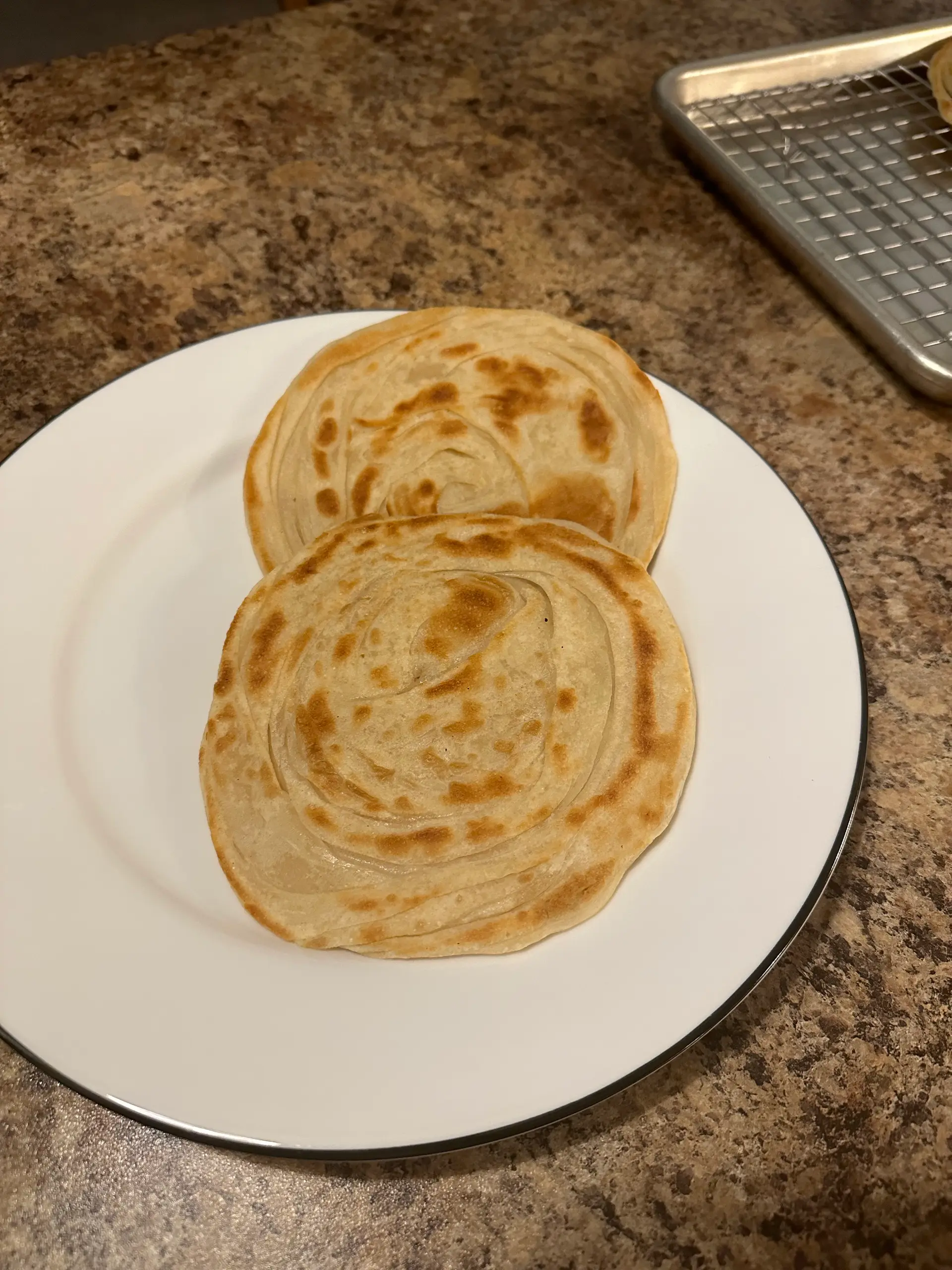 A cook's photo of Parotta